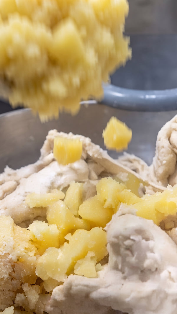 Mash boiled potato into a smooth puree while hot and allow to cool slightly.