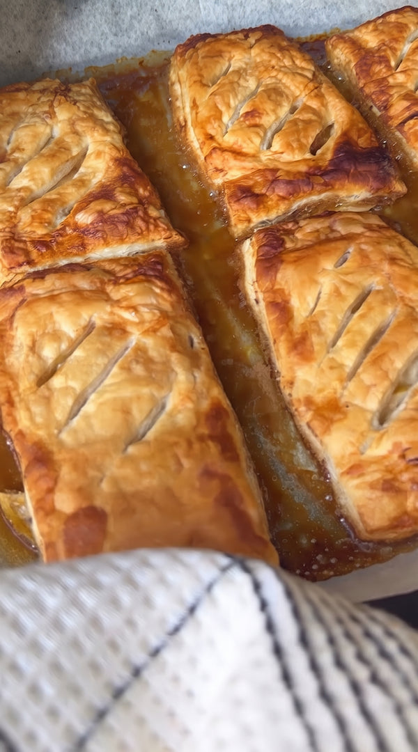 Remove from the oven, let cool for 2 minutes, then carefully flip each tart upside-down so the caramelized apples are on top. Dust generously with powdered sugar and serve warm!