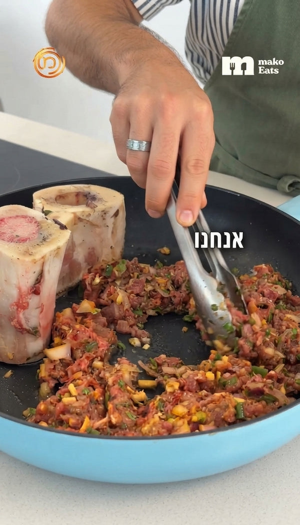 Combine ground lamb, lamb fat, ground beef, minced lamb neck, and cooked bone marrow with finely chopped cilantro, scallions, chili, garlic, Ras el Hanout, paprika, salt, and black pepper. Mix until uniform and let rest.
