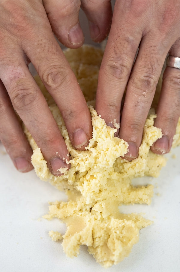 Dust work surface with flour/potato starch. Knead gently by hand until smooth and pliable. Add flour gradually as needed so dough is not sticky