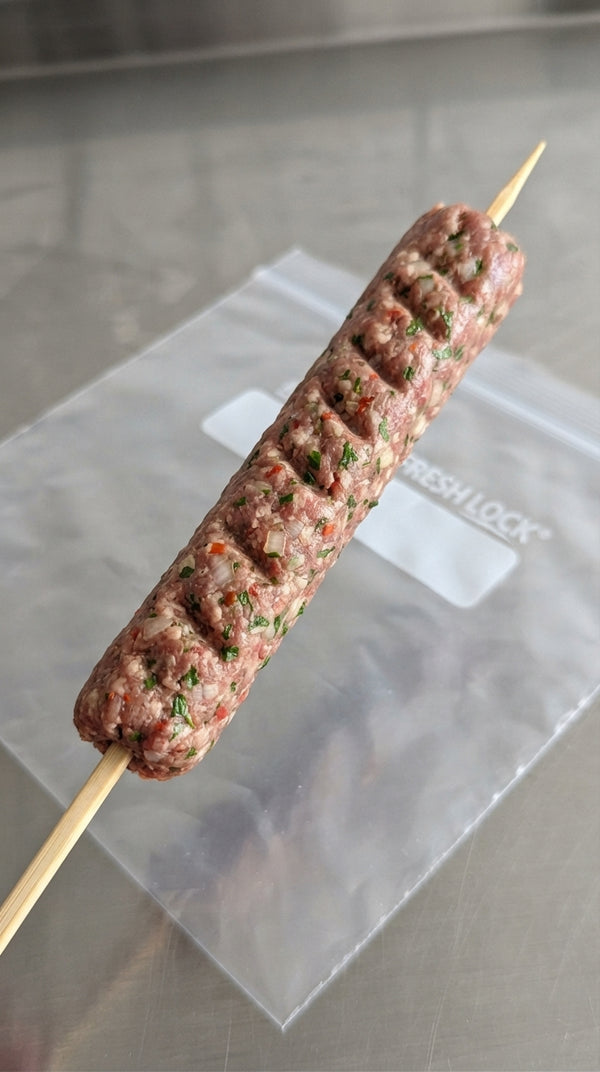 Divide into equal portions and mold around soaked wooden skewers or form sausage-shaped kebabs.